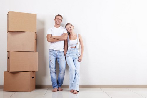 A man with van removal service loading furniture in Wandsworth